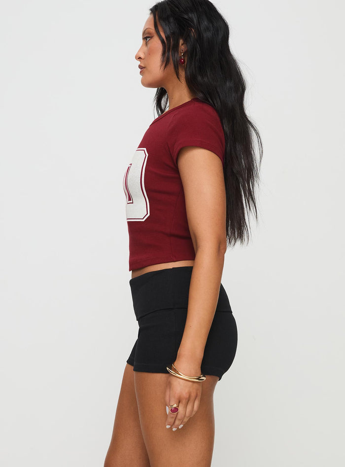 side view of model wearing Princess Polly Baseline Low Rise Rib Shorts Black High Waisted Shorts