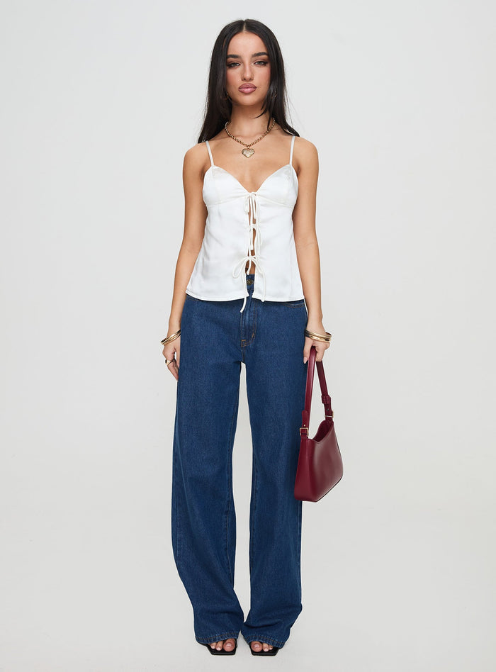 side view of model wearing Princess Polly City Scene Top White Sleeveless Plunger