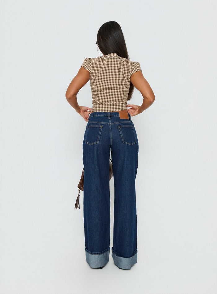 back view of model wearing Princess Polly Darla Low Rise Straight Leg Cuff Jean Dark Blue Wash Low Rise Jeans Jeans
