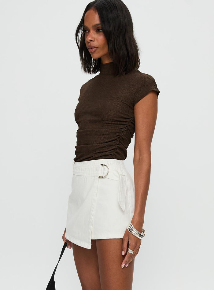 side view of model wearing Princess Polly Elinora Wrap Mini Skirt White Mini Skirts