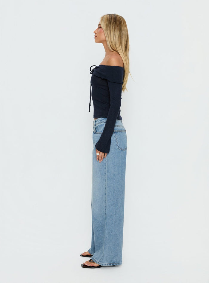 side view of model wearing Princess Polly Ellanor Low Rise Slouch Denim Jean Washed Mid Blue Wash Low Rise Jeans