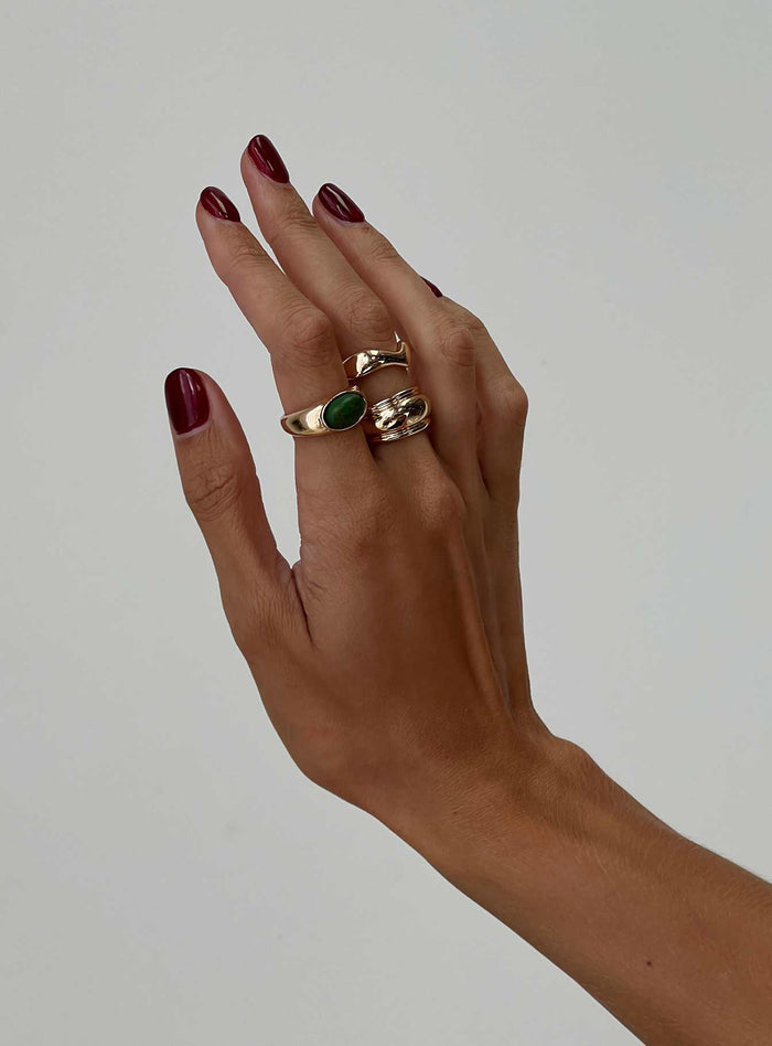 Three rings included, gold-toned, gem detail