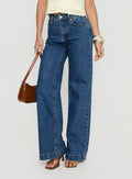side view of model wearing Princess Polly Goldie High Rise Wide Leg Jeans Mid Blue Wash High Rise Jeans