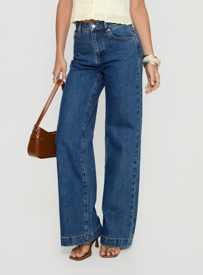 side view of model wearing Princess Polly Goldie High Rise Wide Leg Jeans Mid Blue Wash High Rise Jeans
