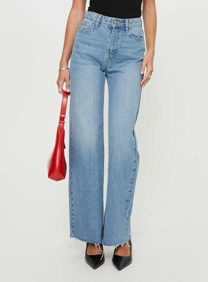 front view of model wearing Princess Polly Henesey Raw Hem Jeans Mid Wash High Waisted