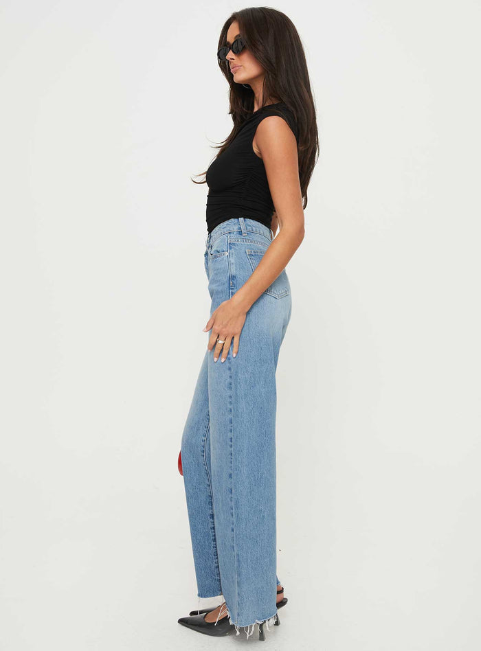 side view of model wearing Princess Polly Henesey Raw Hem Jeans Mid Wash High Waisted