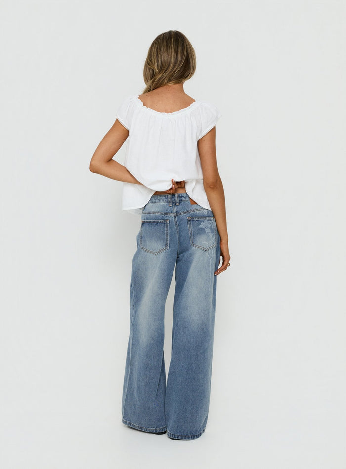 Johnni Floral Printed Low Rise Jeans Mid Wash womens-jeans back view of model wearing Princess Polly