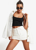 front view of model wearing Princess Polly Katlynne Denim Mini Skort White mid-rise