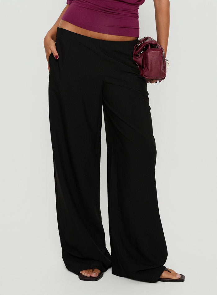 side view of model wearing Princess Polly Khane Low Rise Wide Leg Pant Black Low Rise Pants