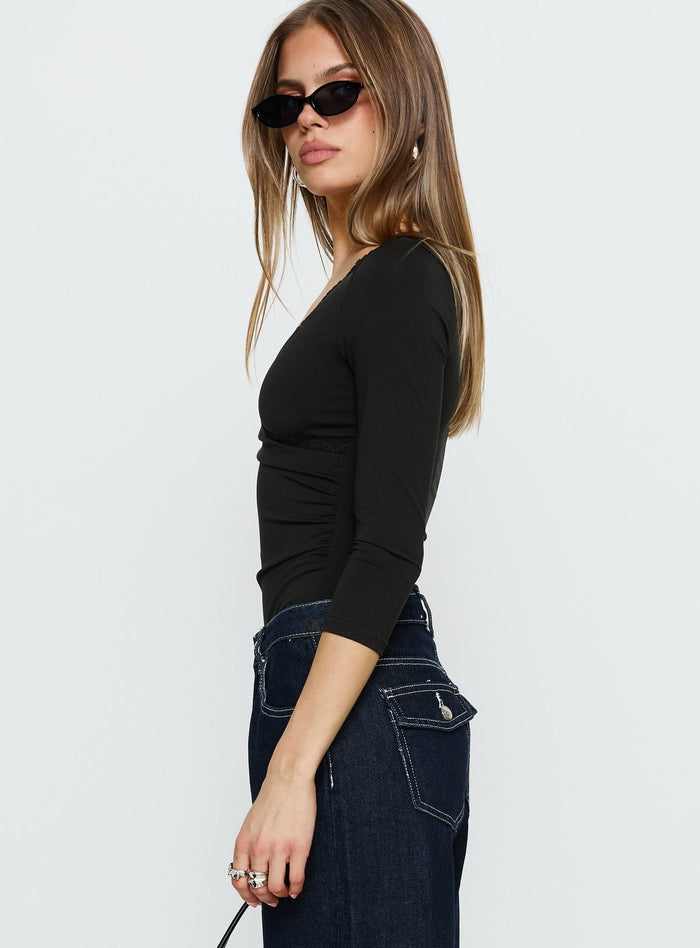 side view of model wearing Princess Polly Lyselle Wrap Detail 3/4 Sleeve Bodysuit Black Quarter Sleeve Bodysuit