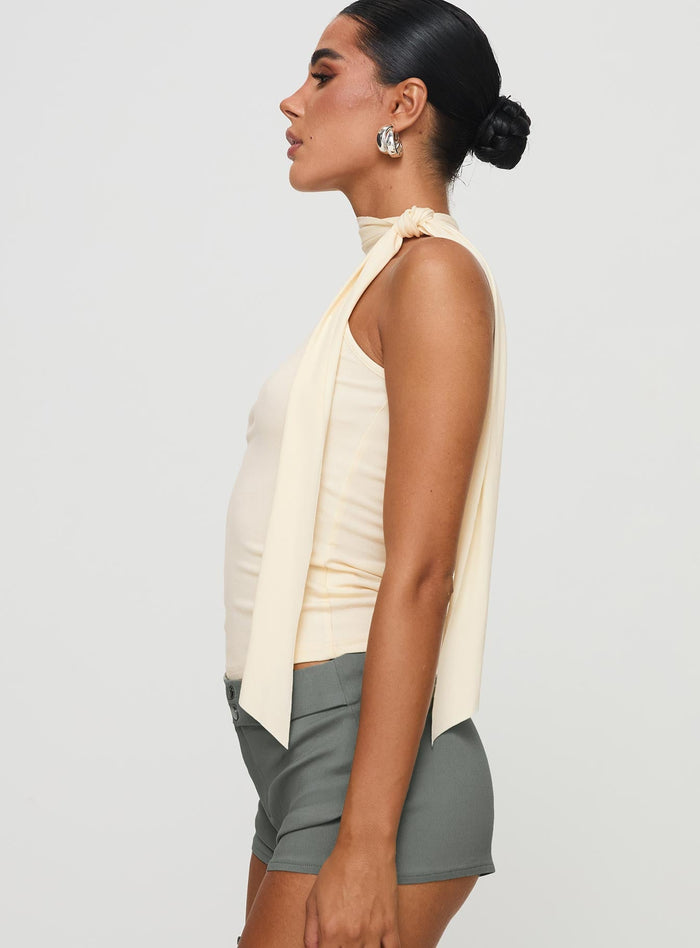 side view of model wearing Princess Polly Mathias Top Cream Sleeveless High Neck