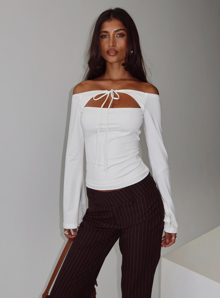 side view of model wearing Princess Polly Nevah Long Sleeve Top White Full Sleeves straight