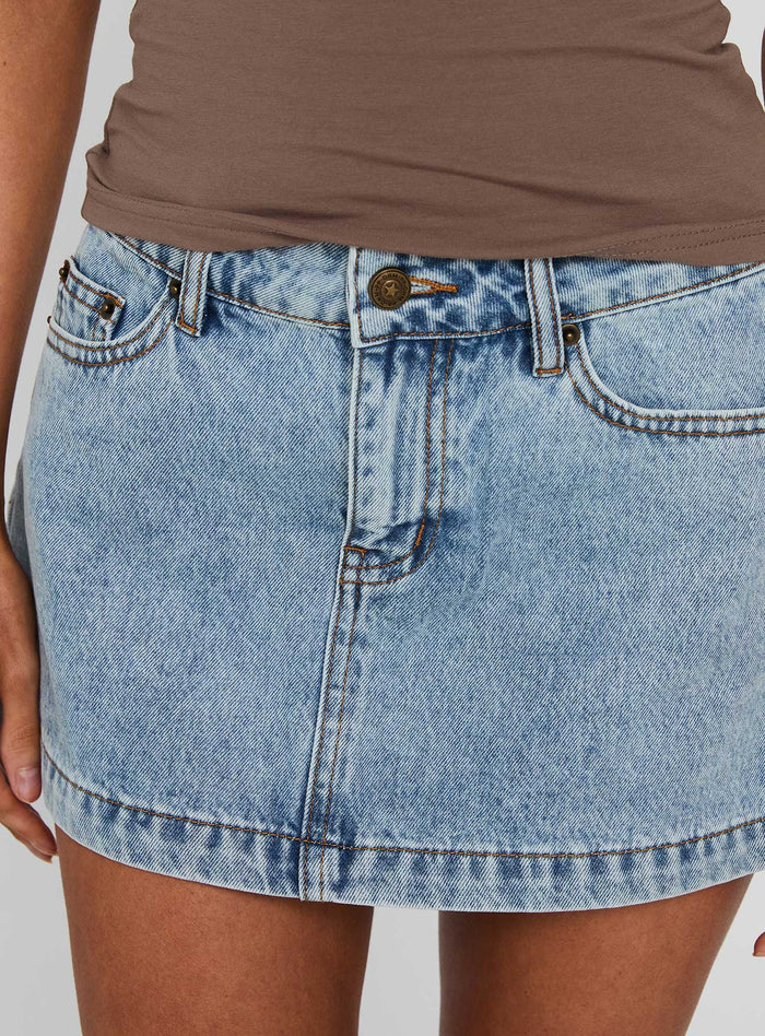 back view of model wearing Princess Polly Nicolina Low Rise Denim Mini Skirt Ice Blue Wash Mini Skirts