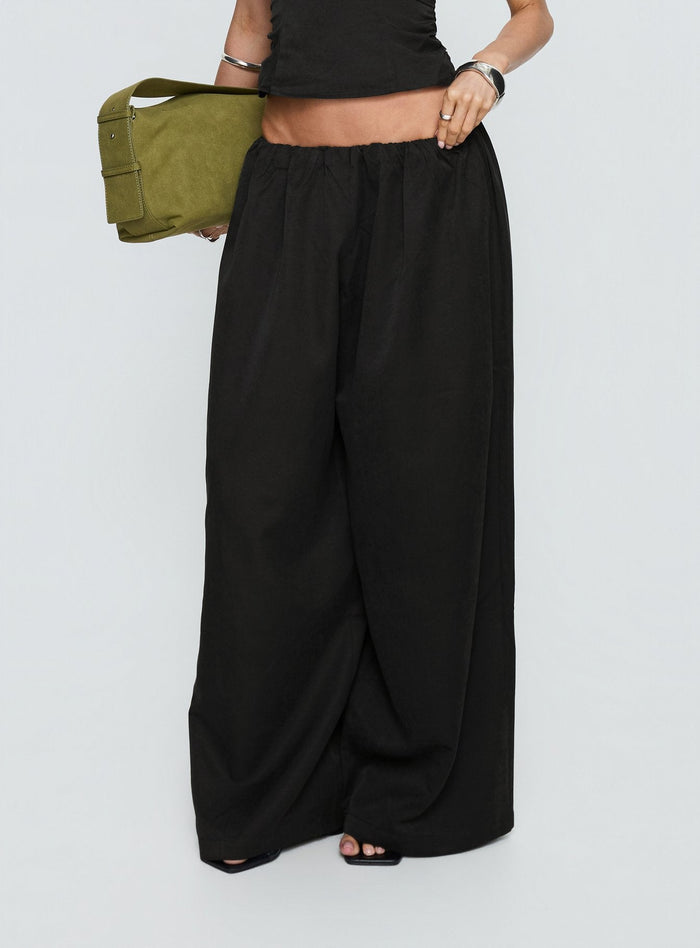 side view of model wearing Princess Polly Odara Wide Leg Pants Black Low Rise Pants