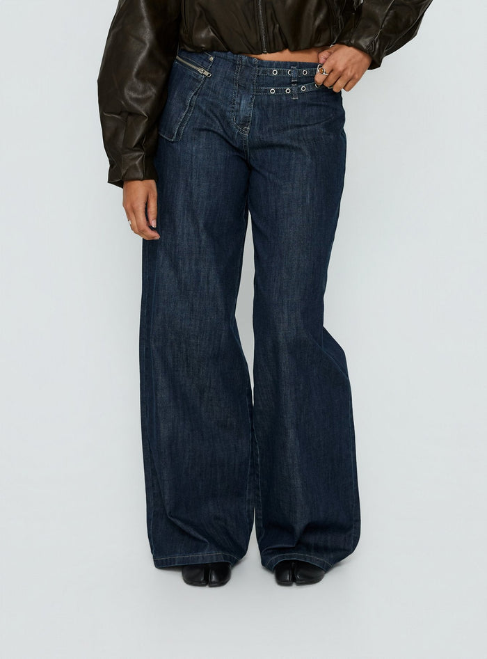 back view of model wearing Princess Polly Paltrow Mid Rise Wide Leg Cargo Jeans Dark Blue Wash Mid Rise Jeans