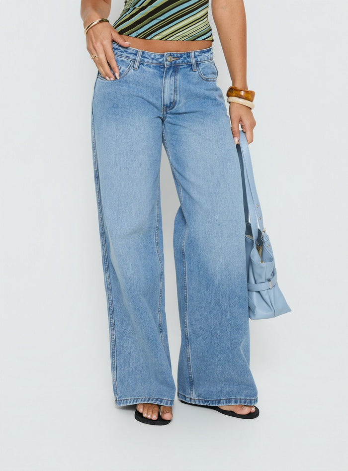 side view of model wearing Princess Polly Ramos Low Rise Wide Leg Denim Jeans Bright Blue Wash Mid Rise Jeans Jeans