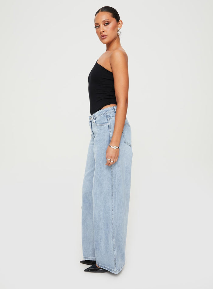 side view of model wearing Princess Polly Ramos Low Rise Denim Jeans Light Wash Petite Low Rise Jeans