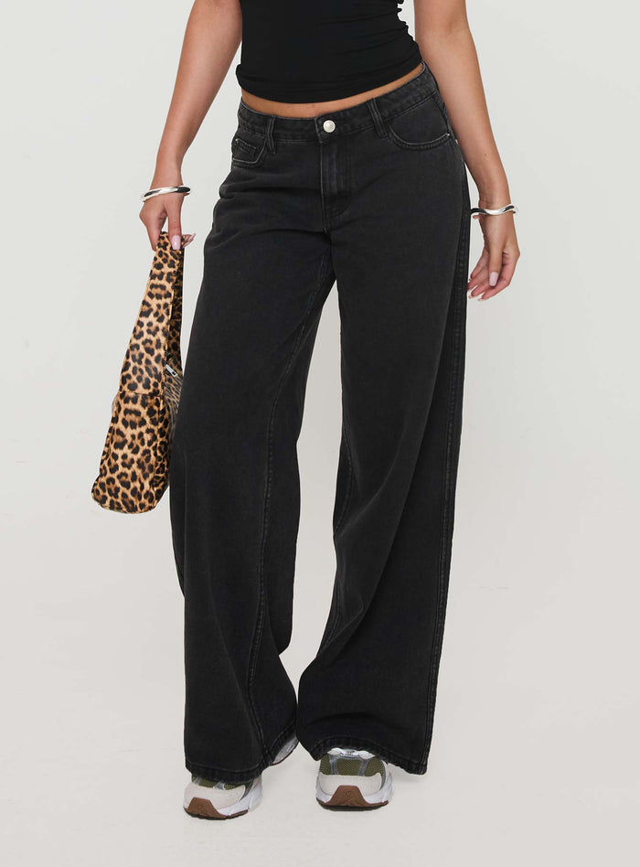 back view of model wearing Princess Polly Ramos Low Rise Denim Jeans Washed Black Petite Low Rise Jeans