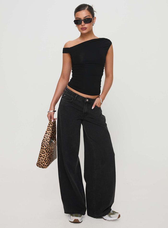 side view of model wearing Princess Polly Ramos Low Rise Denim Jeans Washed Black Petite Low Rise Jeans