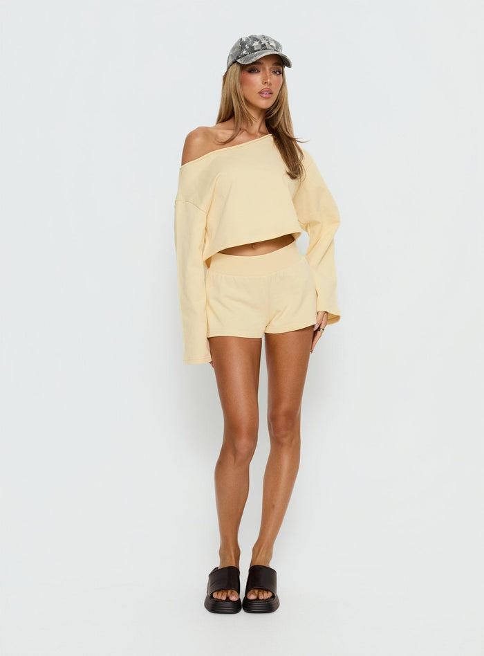 back view of model wearing Princess Polly Retreat Raw Edge Off Shoulder Jumper Buttercream cropped