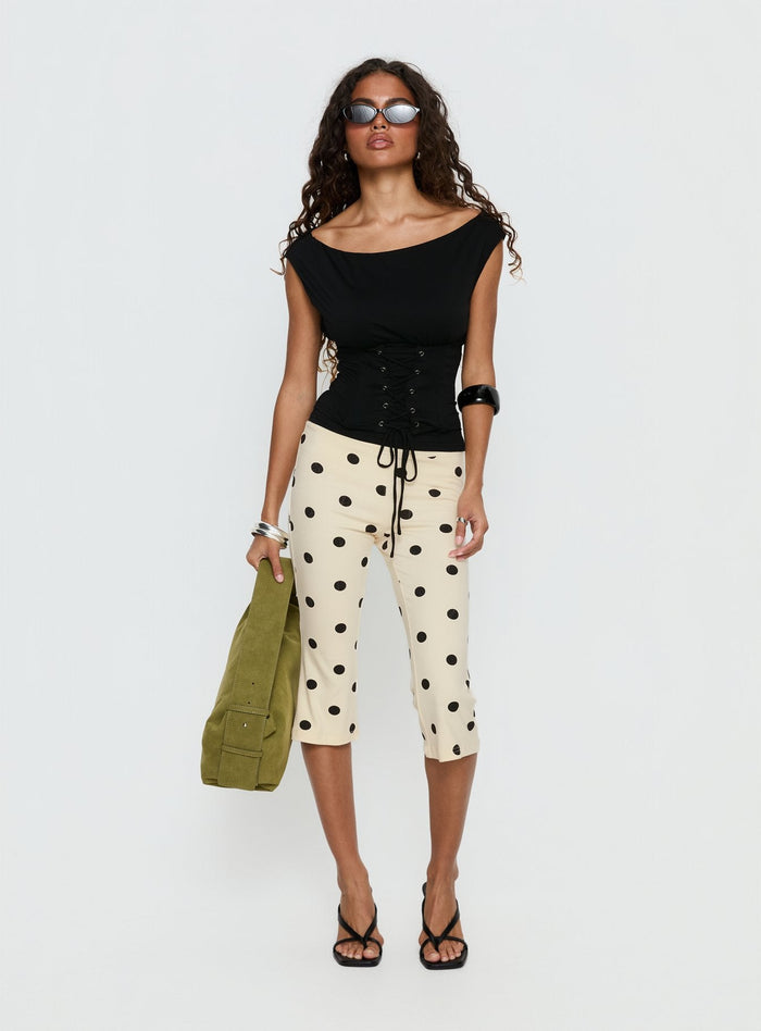 side view of model wearing Princess Polly Samaira Capri Pant Cream Polka Dot Mid Rise Pants