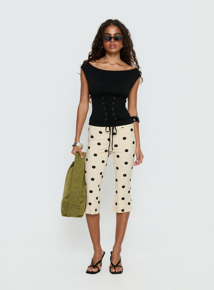 side view of model wearing Princess Polly Samaira Capri Pant Cream Polka Dot Mid Rise Pants