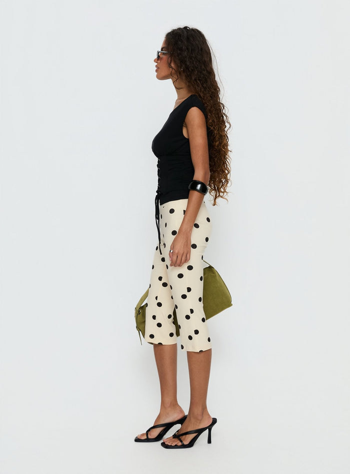 side view of model wearing Princess Polly Samaira Capri Pant Cream Polka Dot Mid Rise Pants