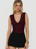 Introducing the Samaria Plunge Neck Bodysuit Burgundy in womens-bodysuit with sleeveless front view of model wearing