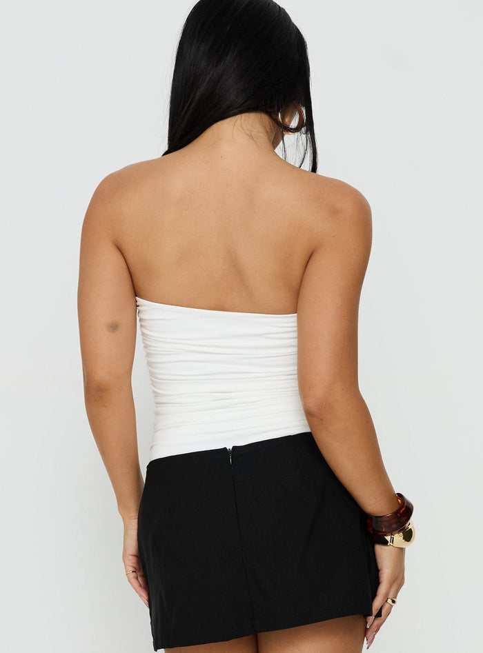 Designed with sleeveless silhouette, the See Me Soon Strapless Hardware Detail Bodysuit White back view of model wearing Princess Polly