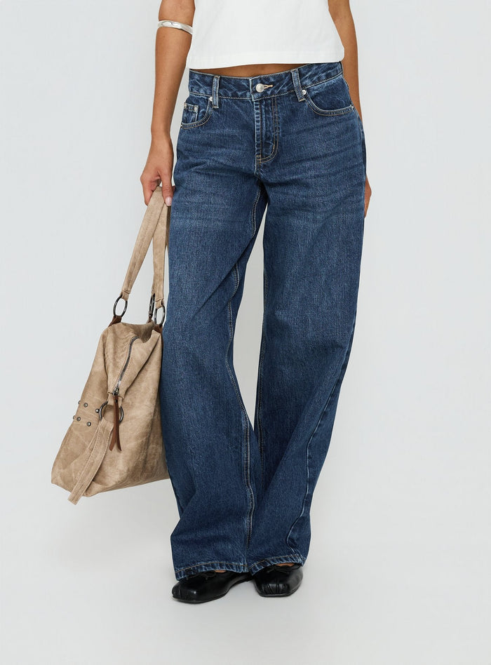 side view of model wearing Princess Polly Serenitia Mid Rise Straight Leg Relaxed Jeans Dark Blue Wash Mid Rise Jeans