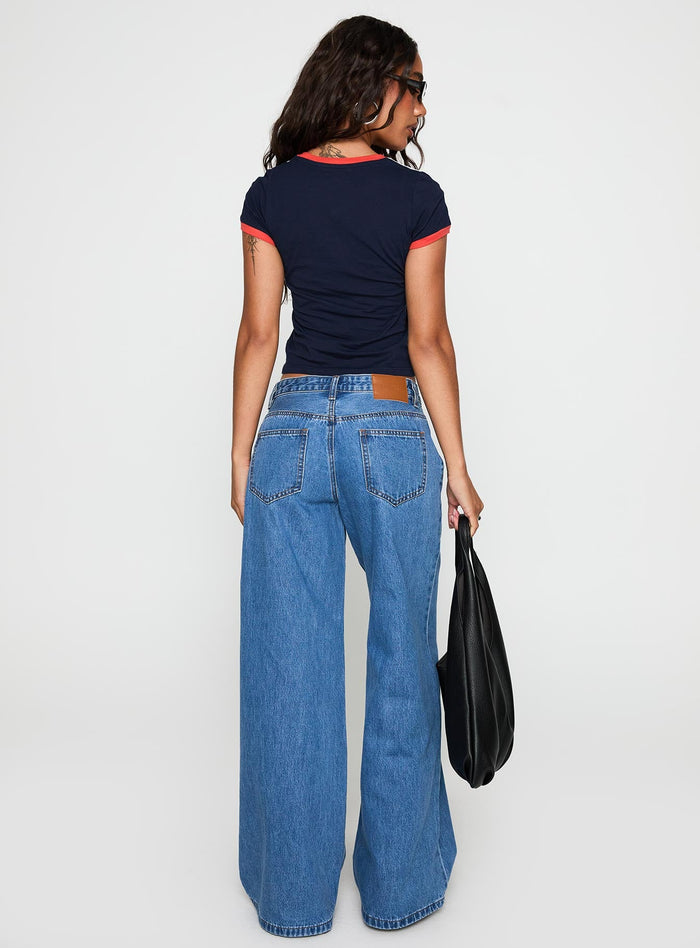 back view of model wearing Princess Polly Supercut Pleat Jean Mid Blue Low Rise Jeans