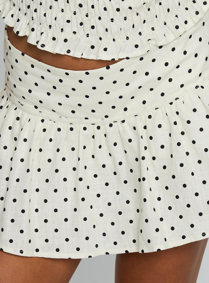 back view of model wearing Princess Polly Tovie Frill Linen Blend Skort Cream Polka Low Rise Shorts