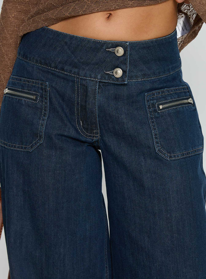 back view of model wearing Princess Polly Unwritten Mid Rise Wide Leg Jeans Dark Blue Wash Mid Rise Jeans