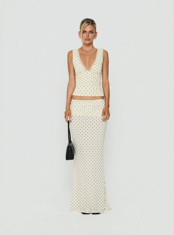 Crafted from jersey fabric the Zespri Maxi Skirt in Cream Polka Dot for womens-skirts with fitted a-line shape and lace hem front view of model wearing Princess Polly